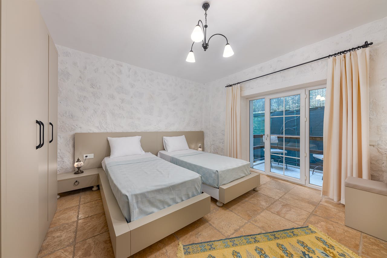 Modern hotel room with twin beds and elegant decor, perfect for travel stays.